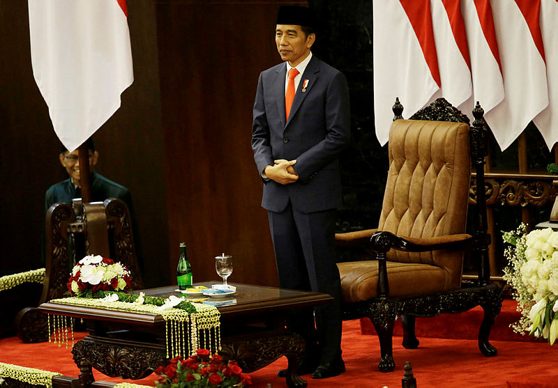 Indonesian President Joko Widodo stands after he was sworn in as president at the parliament building in Jakarta on Oct 20, 2019. — AFP