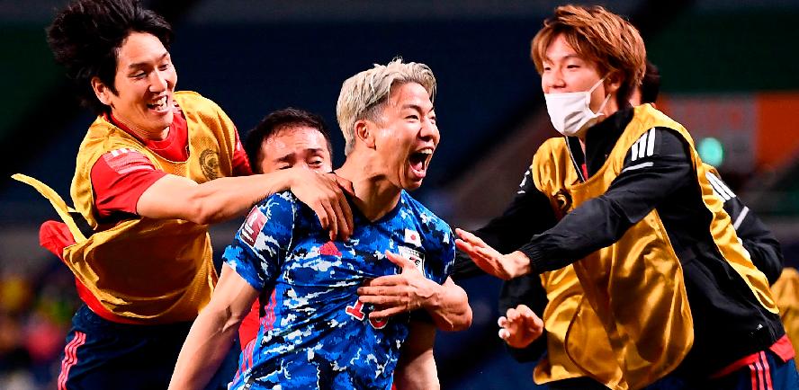 Japan’s Takuma Asano (centre) celebrates with his teammates after Australia’s Aziz Behich (unseen) scored an own goal during the 2022 Qatar World Cup Asian Qualifiers group B match. – AFPPIX