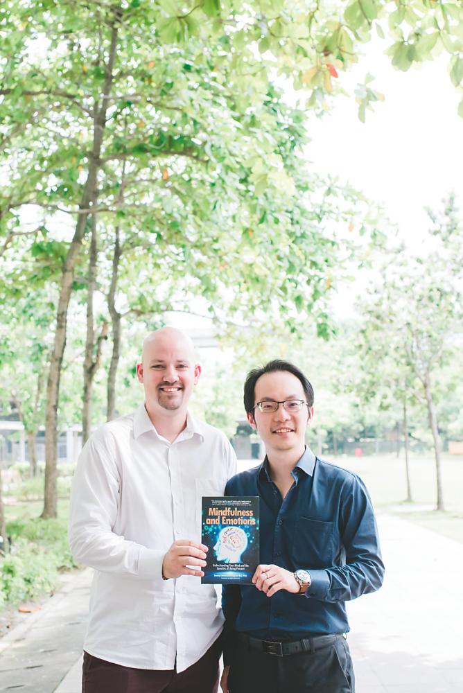 From left: Clarke and Tee with their book on mindfulness and emotions.