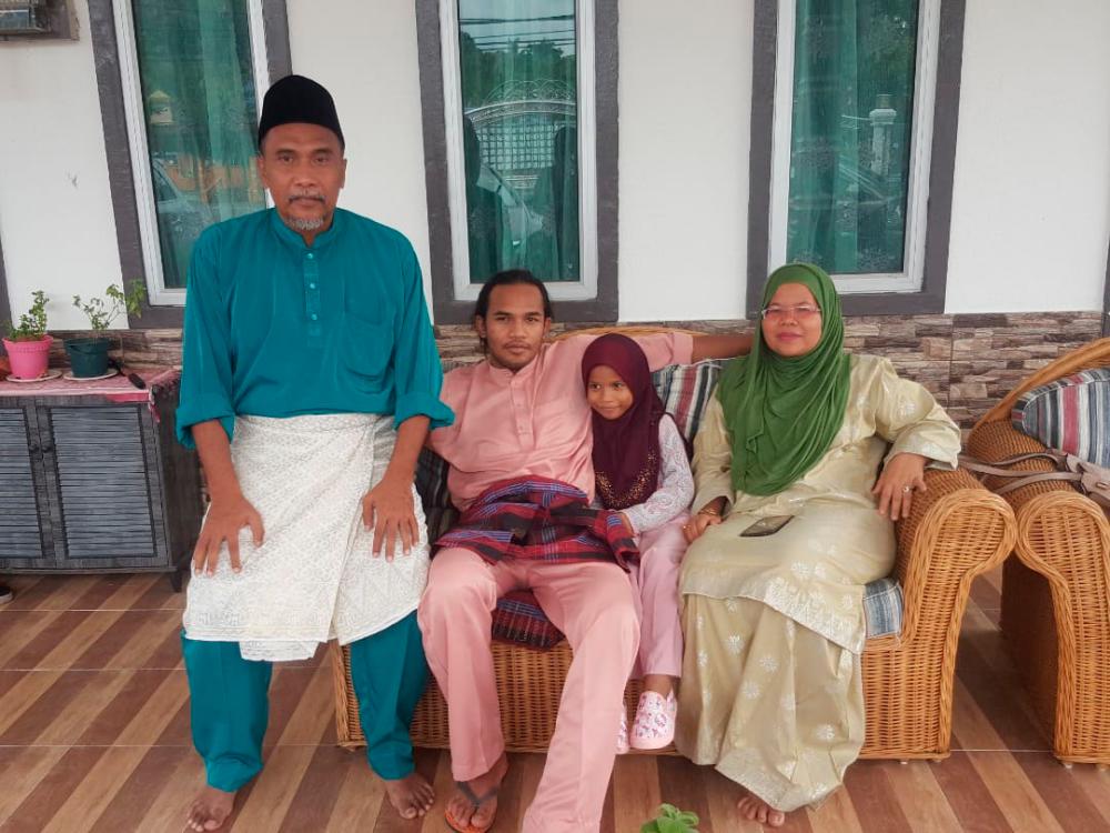 “Jungle Cat” Muhammad Aiman (2nd L) with his family.