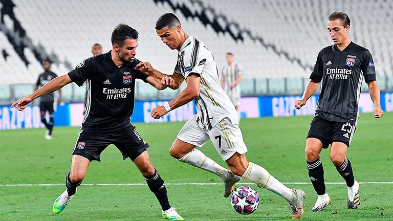 Juventus’ Cristiano Ronaldo (centre) and Lyon’s Leo Dubois (left) in action during the UEFA Champions League round of 16 second leg match at the Allianz Stadium in Turin on Aug 7 2020. – EPAPIX