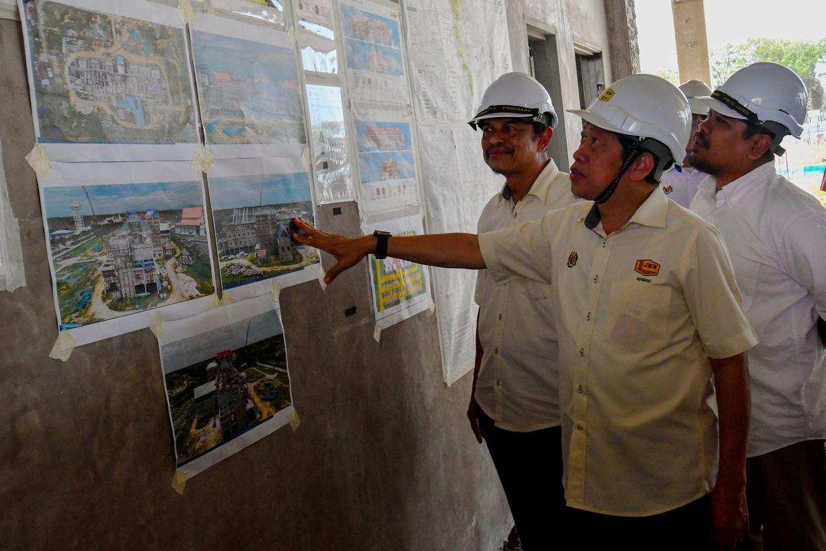 Timbalan Menteri Kerja Raya, Datuk Seri Ahmad Maslan (dua, kanan) melihat pelan Projek Pembinaan Bangunan Kompleks Fakulti Keusahawanan di Universiti Malaysia Kelantan, Kampus Bachok hari ini. - fotoBERNAMA