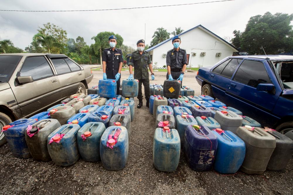 The 7th Battalion of the General Operations Force commanding officer Supt Azhari Nusi (centre) with the confiscated smuggled good at the GOF tactical base in Lubok Setol on Jan 13--fotoBERNAMA (2020) HAK CIPTA TERPELIHARA