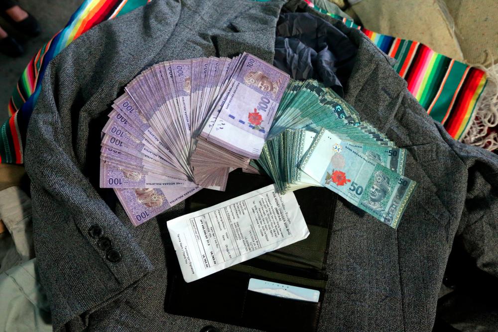 Part of ¥550,000 (RM20,755) that has been converted into local currency after a second-hand clothes seller, Wan Mohamad Adam Wan Mohamed, 29, found a wallet in a bundle of used apparel at his shop in Kampung Tualang Salak, Jelawat, Bachok on Jan 15, 2019. — BBX