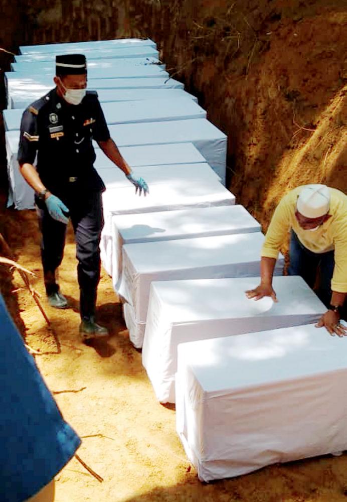 The remains of five orang asli from the Batek tribe being buried at Tanah Perkuburan Islam Kampung Kuala Koh, Gua Musang on June 23, 2019. — BBX