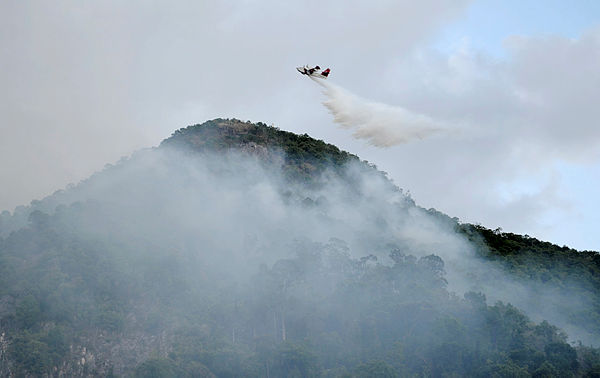 Filepix taken on Feb 13, 2016 shows a Bombardier CL 415P owned by MMEA conducting water bombing to put out a fire at Mount Baling. — Bernama