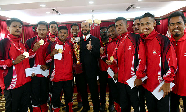 Mentri Besar Datuk Seri Mukhriz Tun Dr Mahathir (centre) posing for a picture together with the National Handicapped Football Squad, which emerged as champions in the Special Olympics International Football Championship recently.