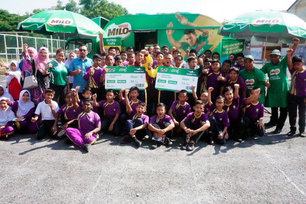 Adam Muqhriz Mohd Izham (8th from R) and classmate, Aqil Danish Putra Rozaidi (10th from L) pictured with schoolmates at a ceremony held here to announce the participation of the two boys, who will represent Malaysia in the Milo Champions Cup in Barcelona, Spain next month. - Bernama