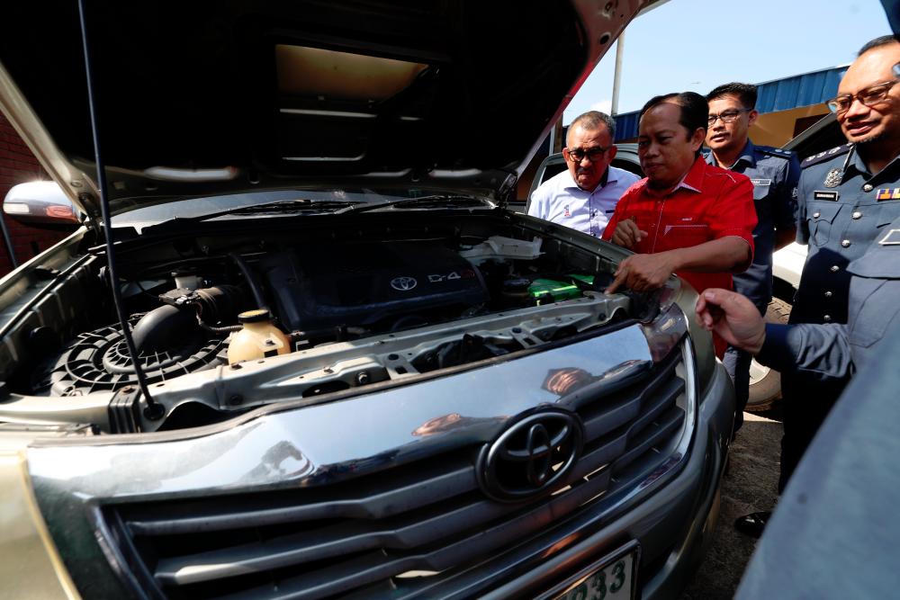 Datuk Seri Ahmad Maslan melihat antara kenderaan yang berjaya dirampas yang terlibat dengan penyeludupan diesel ketika mengadakan lawatan ke Stor Penguatkuasaan Jabatan Kastam Diraja Malaysia hari ini./FOTOBERNAMA