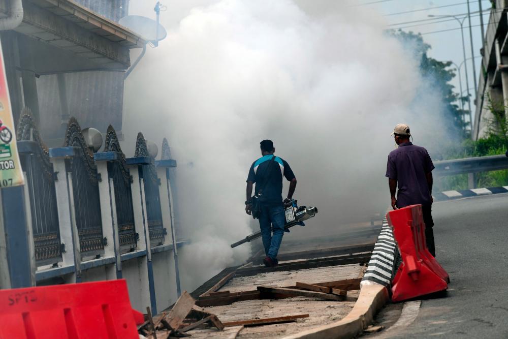 Kota Setar district health services staff perform fogging operations at a row of shops near the City Plaza shopping center on June 25, 2019 to handle the Chikungunya outbreak. - Bernama