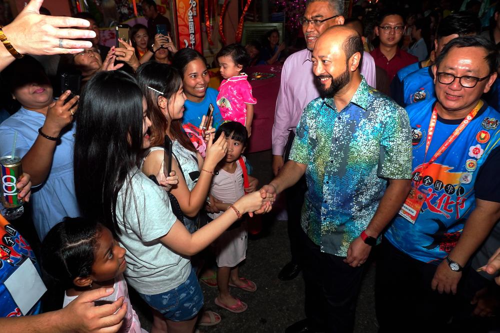 Kedah Mentri Besar Datuk Seri Mukhriz Tun Mahathir shakes hands with the crowd at the opening of Kampung Warisan Kebudayaan in conjunction with the 36th Malaysia Chinese Cultural Festival in Alor Star on the night of Sept 6, 2019. - Bernama