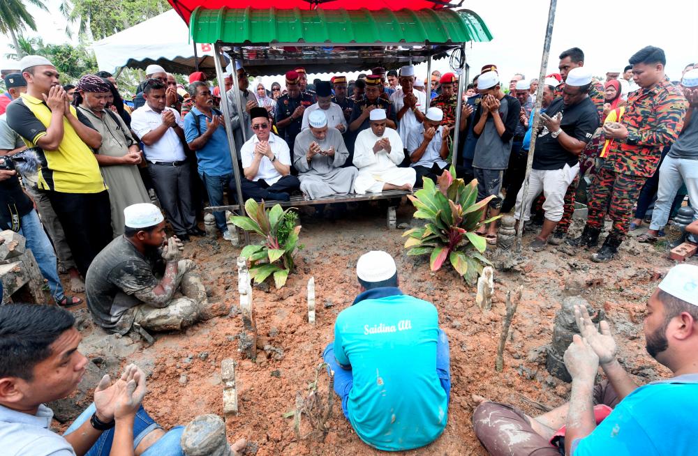 A prayer is held during Muhammad Adib Mohd Kassim’s funeral at Tanah Perkuburan Islam Kariah Masjid As-Saadah Kampung Tebengau, Alor Star on Dec 18, 2018. — Bernama