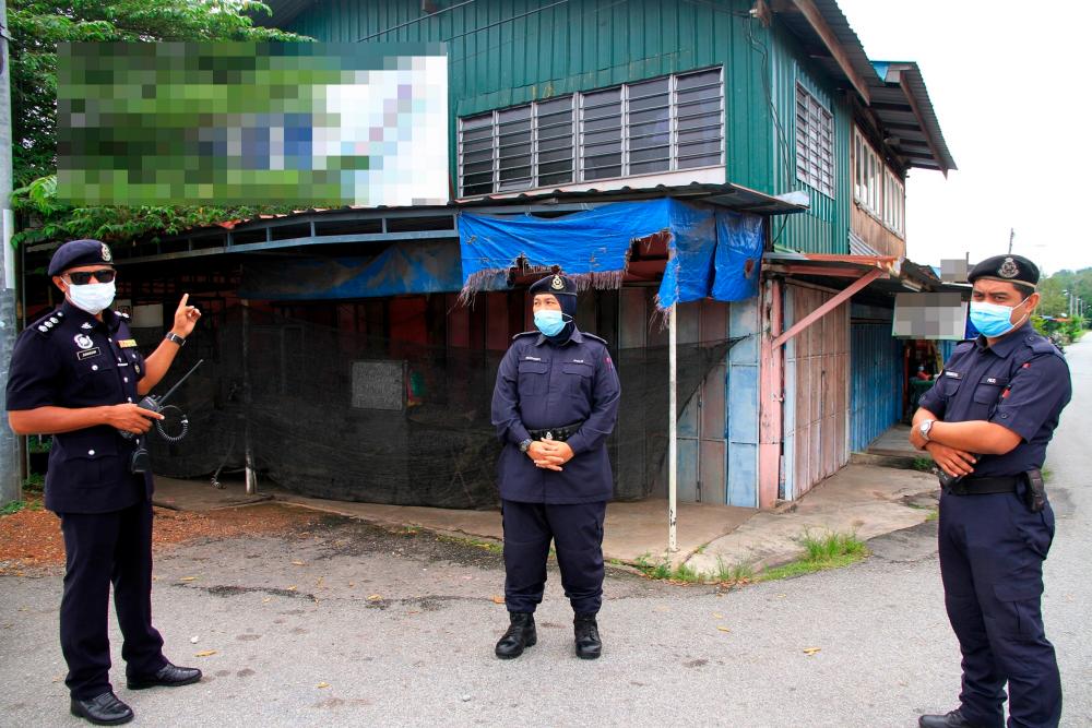 Police guard a premises a Covid-19 hotspot in Kubang Pasu, on July 29, 2020. — Bernama
