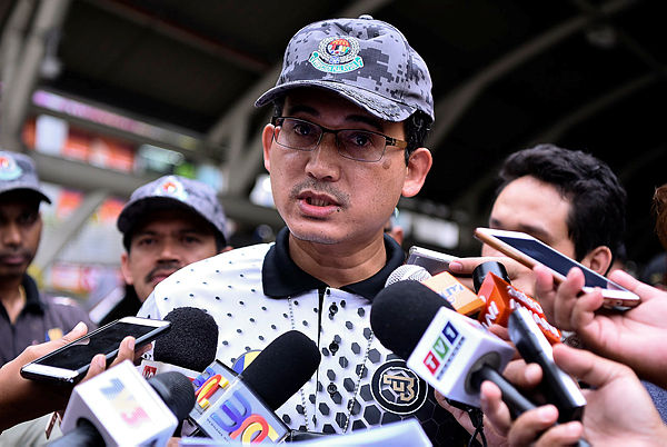 Immigration Department director-general Datuk Khairul Dzaimee Daud speaks to the media after conducting Immigration enforcement operations around Jalan Silang, Kuala Lumpur. — Bernama