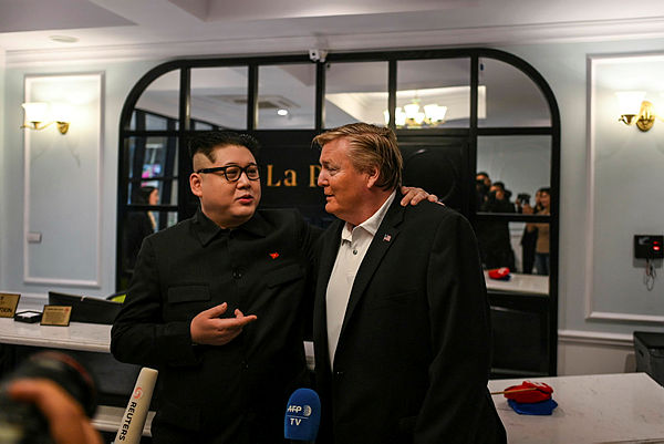 The impersonators of North Korean leader Kim Jong Un (Howard X) (L) and US President Donald Trump (Russel White) speak to the media at a hotel before being escorted by Vietnamese authorities to the airport, in Hanoi on Feb 25, 2019.