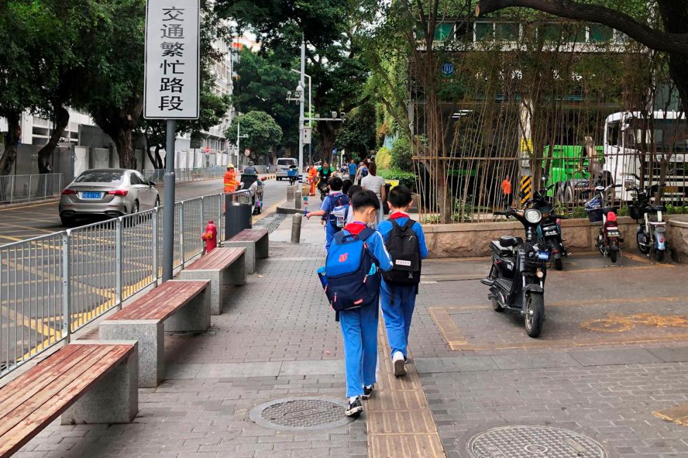 Children leave a school in Shekou area of Shenzhen, Guangdong province, China April 20, 2021. REUTERSPix