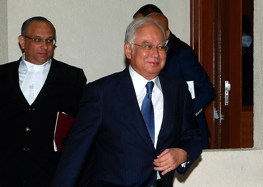 Former Prime Minister Datuk Seri Najib Abdul Razak leaves the courtroom after case management over seven charges involving SRC International Sdn Bhd amounting to RM42 million before High Court Judge Mohd Nazlan Mohd Ghazali, today. - Bernama