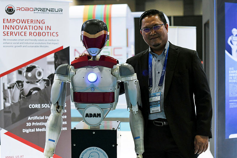 Roboprenuer Sdn Bhd Founder and CEO, Dr Hanafiah Yussof, with Adam the humanoid robot during the 2019 Beyond Paradigm Summit at Malaysian International Trade and Exhibition Centre, on July 18, 2019. — Bernama