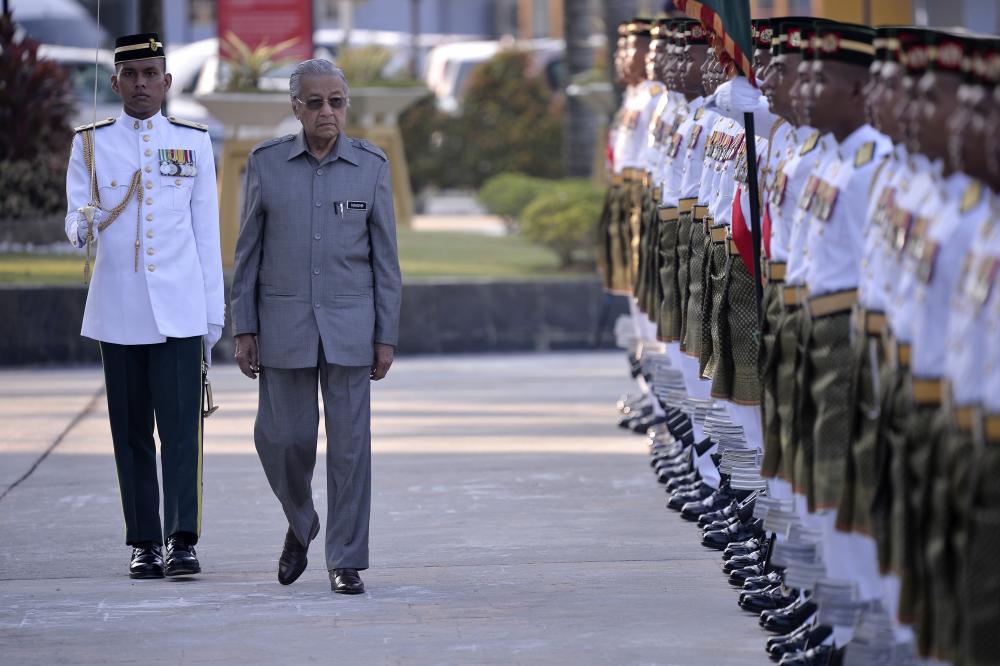Prime Minister Tun Dr Mahathir Mohamad inspects the prime honor of the First Battalion of the Royal Malay Regiment at the Defence Ministry in conjunction with his official visit, on Feb 21, 2019. — Bernama