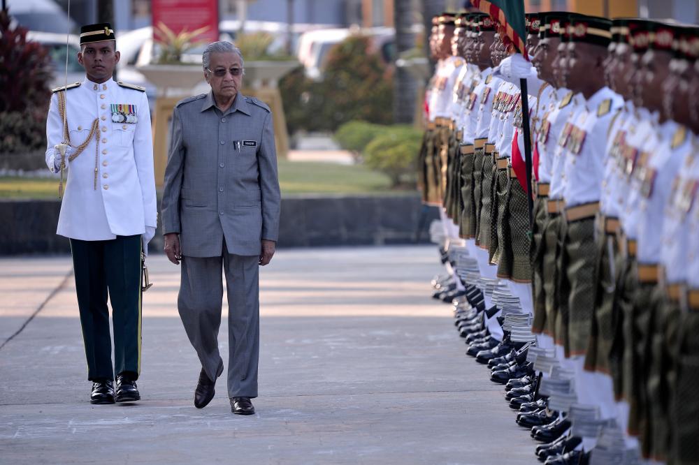 Prime Minister Tun Dr Mahathir Mohamad inspects the honour guard from the First Battalion of the Royal Malay Regiment at Dataran Wisma Pertahanan in Kuala Lumpur on Feb 21, 2019. — Bernama