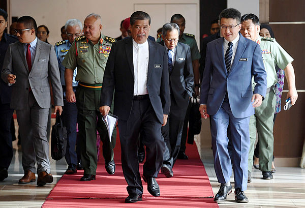Defense Minister Mohamad Sabu walks with Senator Liew Chin Tong (R) during the presentation on ‘Navigating the Risks of Thucydides Trap: US-China Relations and Southeast Asian Responses’ in Kuala Lumpur on Jan 22, 2019. — Bernama