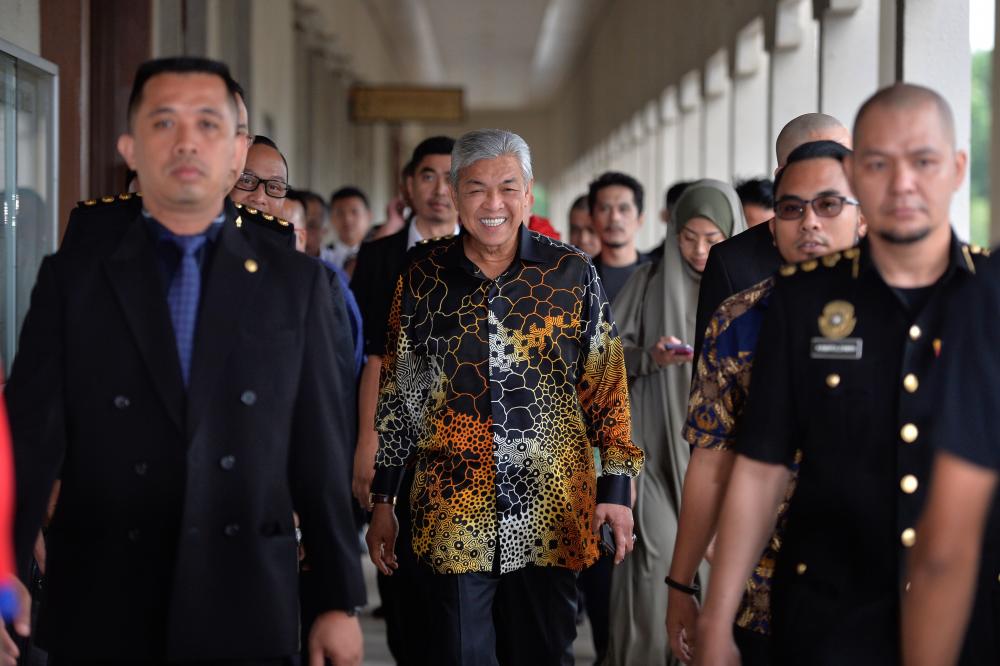 Former deputy prime minister Datuk Seri Dr Ahmad Zahid Hamidi (C) pleaded not guilty at the Kuala Lumpur sessions court on June 26, 2019, on seven charges of receiving bribes from a company amounting to S$4.24 million to handle a foreign visa system. - Bernama