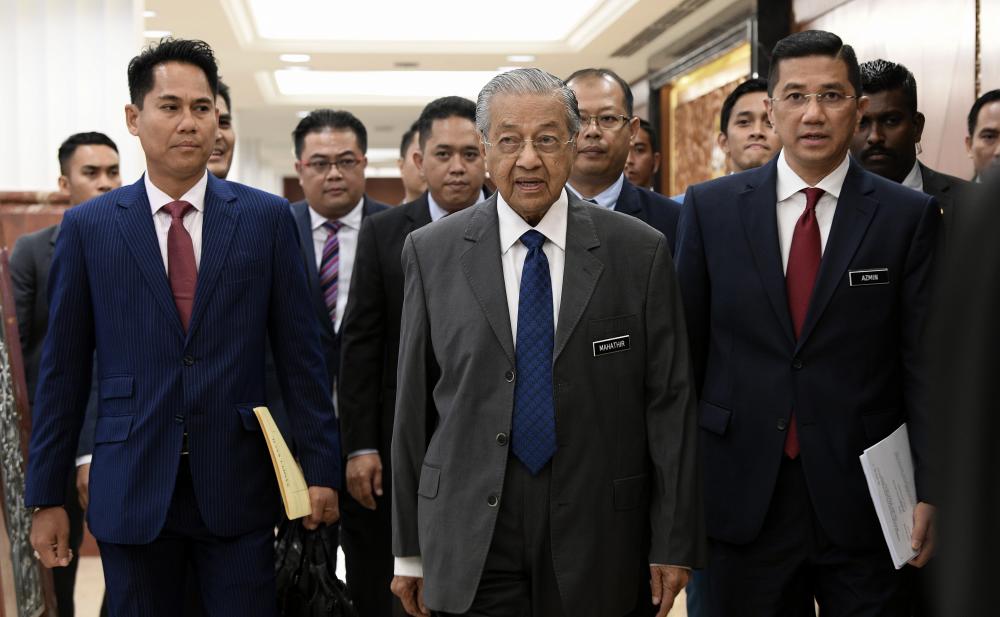 Prime Minister Tun Dr Mahathir Mohamad and Economic Affairs Minister Datuk Seri Mohamed Azmin Ali (right) arrive at the Dewan Rakyat sitting in Parliament, on April 4, 2019. — Bernama