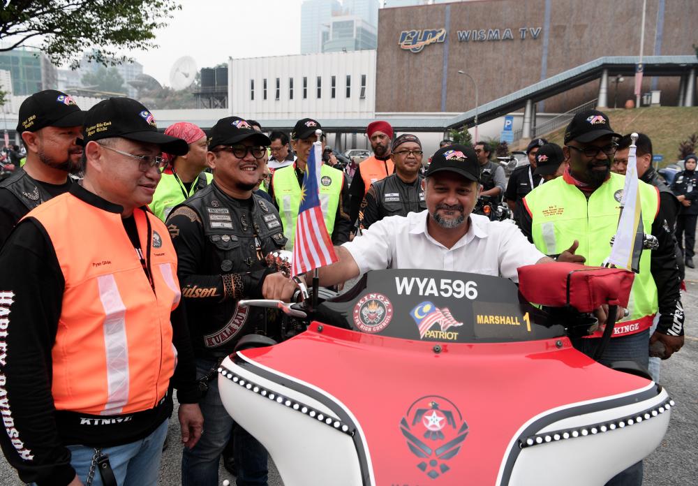 Communications and Multimedia Minister Gobind Singh Deo tries out a high-powered bike during the flagging-off ceremony of the Kingz Annual Ride (KAR) to forge greater unity among themselves and promote healthy living through the motorsport activity, on Sept 13, 2019. — Bernama