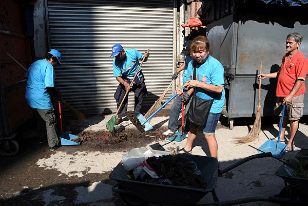 Participants help clean the area around Jalan Haji Taib in the capital, as part of a gotong-royong programme on Dec 24, 2018. — Bernama