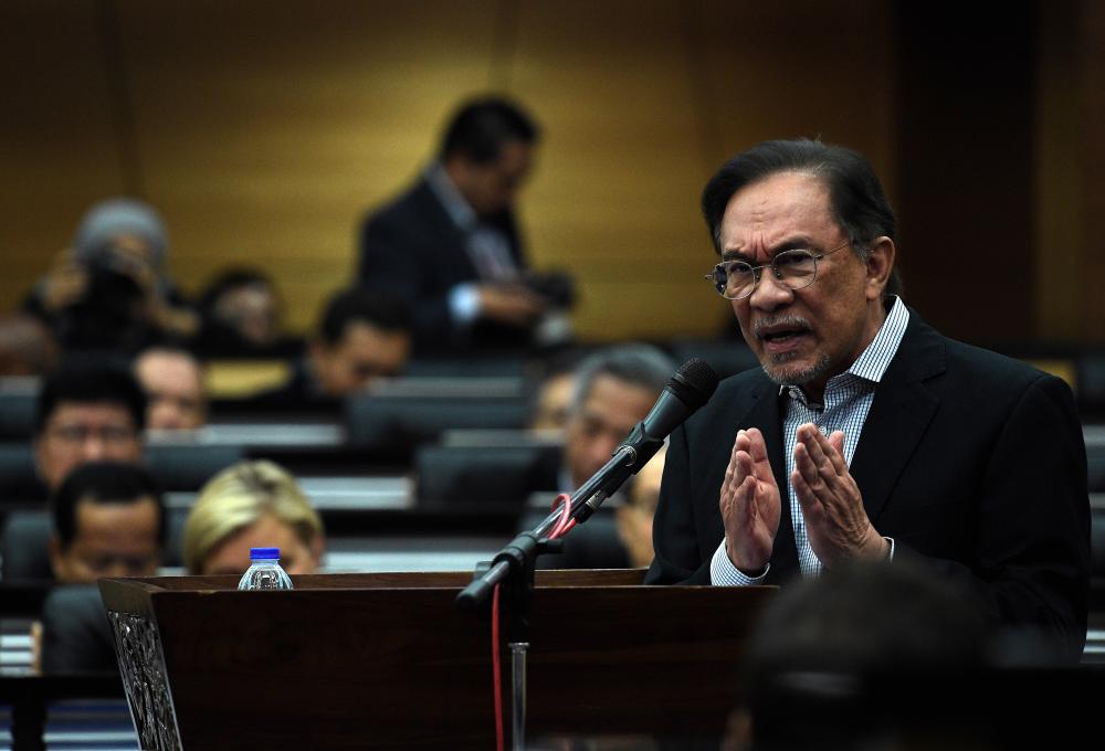 Chairman of the parliamentary Caucus on Reform and Governance Datuk Seri Anwar Ibrahim delivers during the Malaysian Economic Symposium themed ‘Malaysian Economy: Now and the Future’ in Parliament today. - Bernama