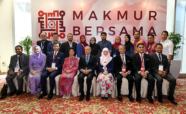 Prime Minister Tun Dr Mahathir Mohamad (seated, center) together with his wife and other Cabinet ministers at the launch of the Shared Prosperity Vision 2030 (WKB2030) document at KLCC today. — Bernama