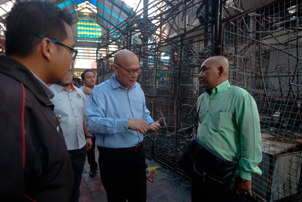 Kuala Lumpur Mayor Datuk Nor Hisham Ahmad Dahlan (C) visits the scene in front of Wisma Yakin, Masjid India which went aflame early this morning. - Bernama