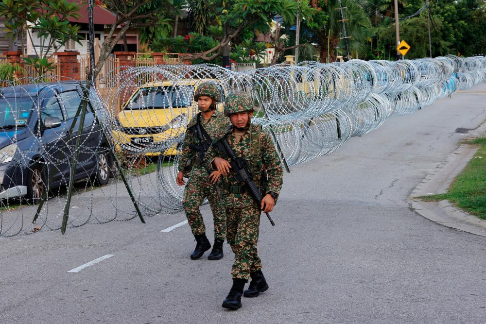 Officers from the Malaysian Armed Forces patrol the an area in Old Town, Petaling Jaya, on May 11, 2020. — Bernama