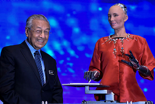 Sophia (right), the social humanoid robot alongside Prime Minister Tun Dr Mahathir Mohamad at the Beyond Paradigm Summit held at the Malaysia International Trade and Exhibition Centre yesterday.