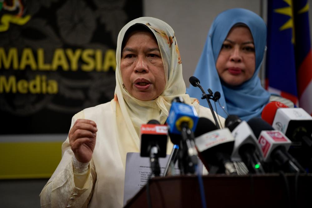 Housing and Local Government Minister Zuraida Kamaruddin (L) speaks to the media during a press conference in Parliament today. - Bernama