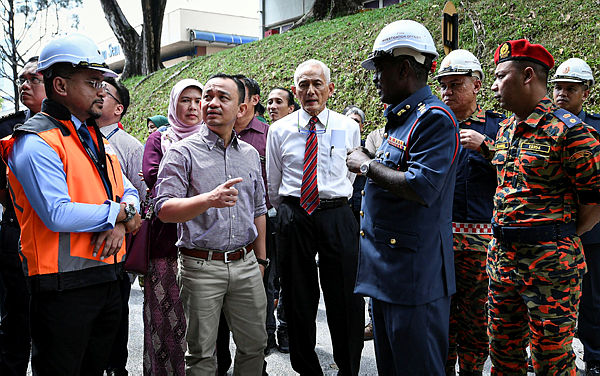 Education Minister Dr Maszlee Malik (2nd from L) visits the UM Faculty of Economics and Administration fire site today. — Bernama
