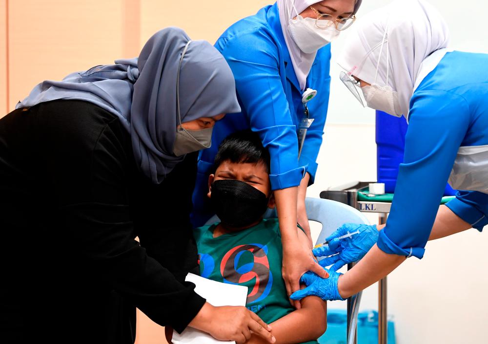 KUALA LUMPUR, 3 Feb -- Ragam adik Usaid Muzaffar Mohd Azlan, 6, ketika divaksinasi pada Program Imunisasi COVID-19 Kanak-kanak (PICKids) Lima hingga Bawah 12 Tahun di Hospital Tunku Azizah Kuala Lumpur hari ini. -- fotoBERNAMA