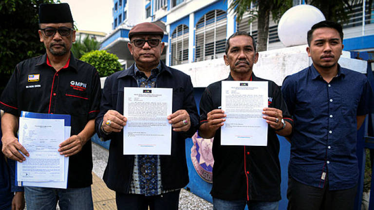 Picture used for representational purposes. GMPN president Razali Zakaria (L) shows a copy of the police report lodged at Dang Wangi police headquarters on June 2, 2019. — Bernama