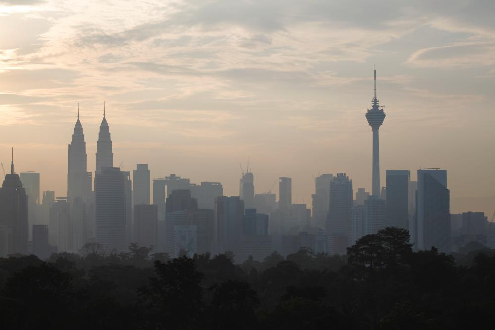 An aerial view of the capital’s skyscrapers shows the setting of the sun with clear skies during an inspection of the haze situation today. - Bernama