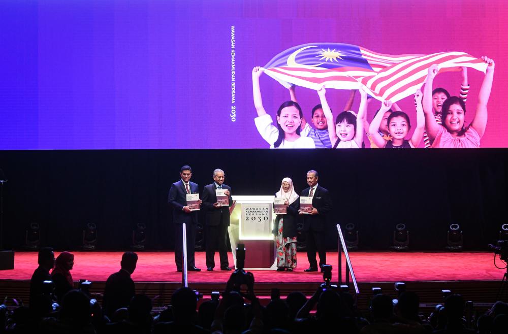 Prime Minister Tun Dr Mahathir Mohamad shows off the Shared Prosperity Vision 2030 (WKB2030) book when launching the WKB2030 today.  Also present were Deputy Prime Minister Datuk Seri Dr Wan Azizah Wan Ismail (2nd from R), Home Minister Tan Sri Muhyiddin Yassin (R) and Economic Affairs Minister Datuk Seri Mohamed Azmin Ali (L).  - Bernama