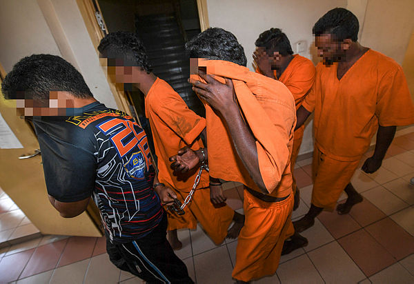 Five men believed to have been involved in the riot incidents at the Sri Maha Mariamman Temple arrived at the Petaling Jaya Court Complex on Dec 10, 2018. — Bernama