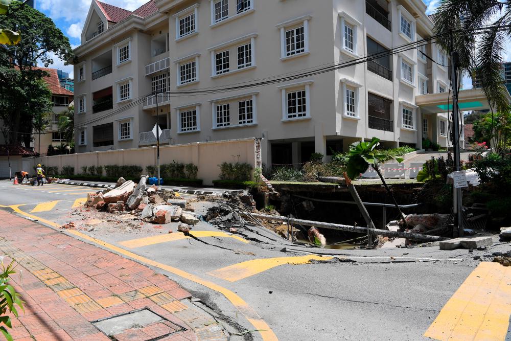 Repair works on two sinkholes at Residency 16, Jalan Taman U Thant in Kuala Lumpur was in full swing during a survey today. - Bernama