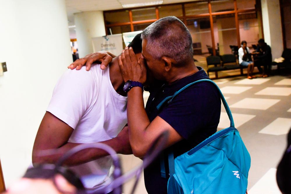 The 56-year-old father and his 19-year-old son embrace each other after the High Court acquitted the child of the charge of killing 23 people at the Pusat Tahfiz Darul Quran Ittifaqiyah in Kuala Lumpur almost three years ago. - Bernama