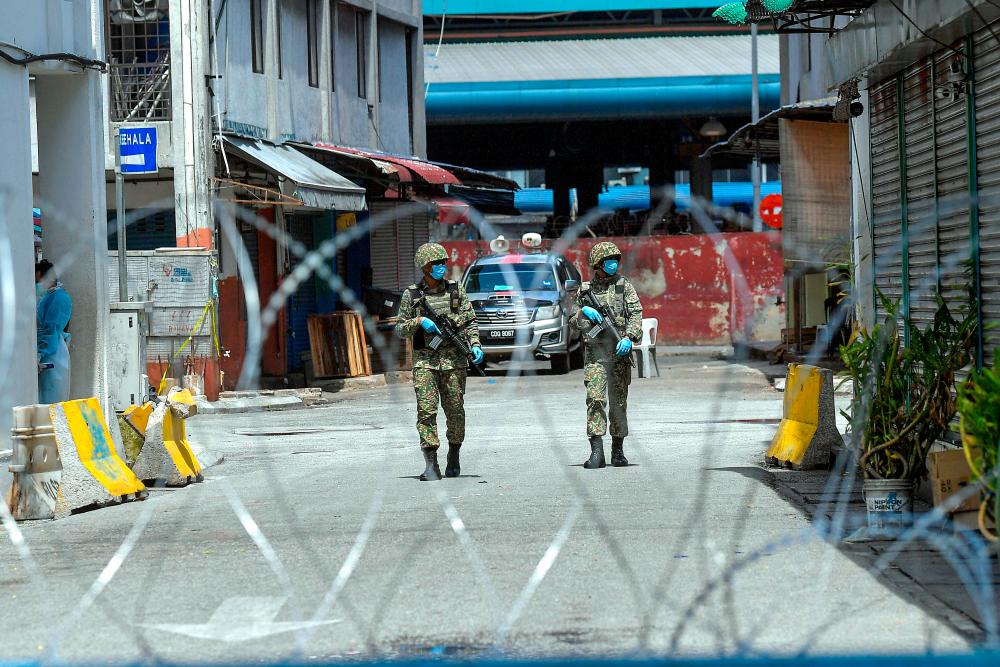 Officers from the Malaysian Armed Forces at one of the areas in Selayang under the enhanced movement control order (EMCO), on April 23, 2020. — Bernama