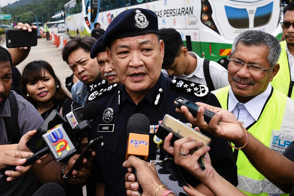 IGP Datuk Seri Abdul Hamid Bador speaks during a brief press conference at the Gombak Toll Plaza today after handing over porridge to road users who were on their way home to celebrate Aidilfitri. - Bernama