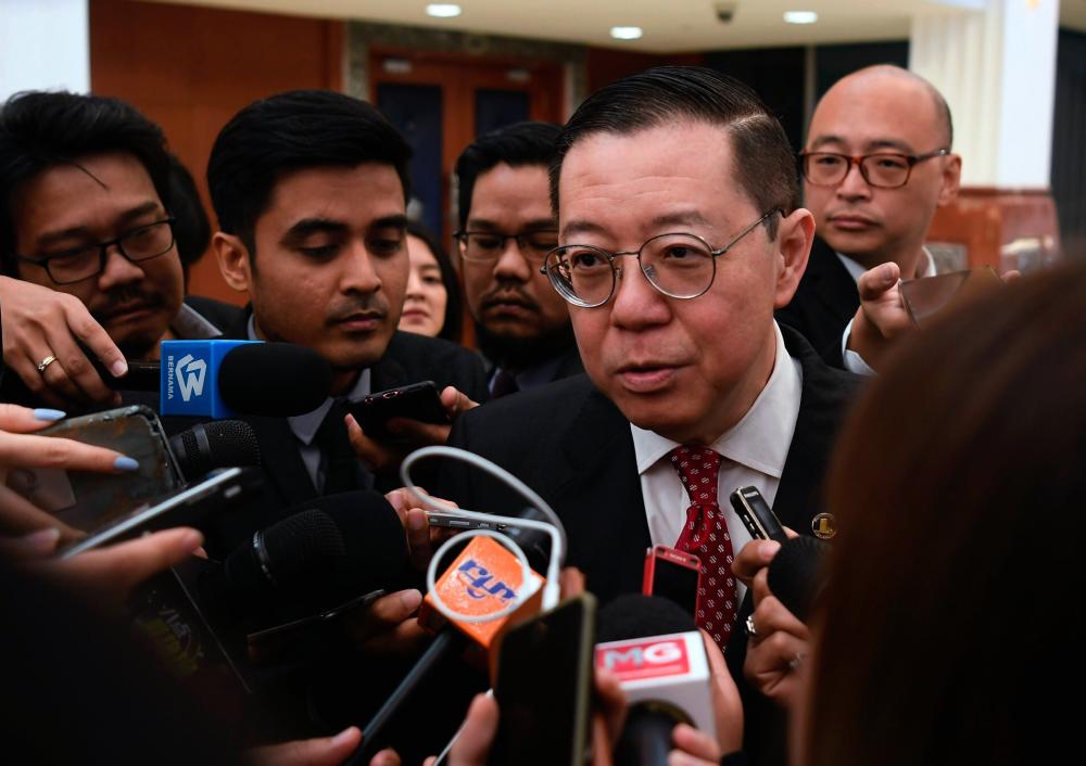 Finance Minister Lim Guan Eng speaks to reporters in the Parliament lobby today. - Bernama