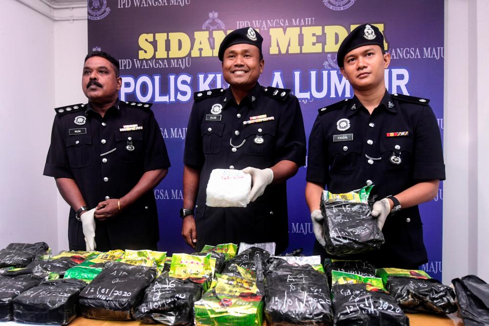 Wangsa Maju district police chief Supt Rajab Sunday Ismail (C) shows off the more than 18.9 kg of drugs seized from a man in Setiawangsa worth RM948,000 last week, at the Wangsa Maju district police headquarters today. - Bernama