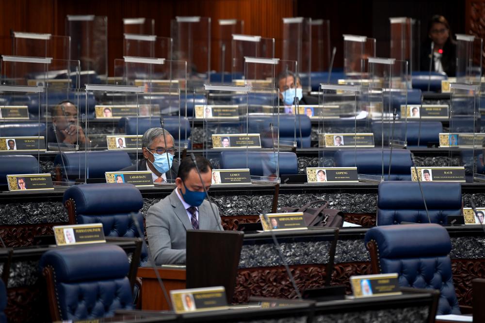 MPs seated at their respective seats which have now been installed with transparent barriers in a bid to prevent the spread of the Covid-19 virus. — Bernama