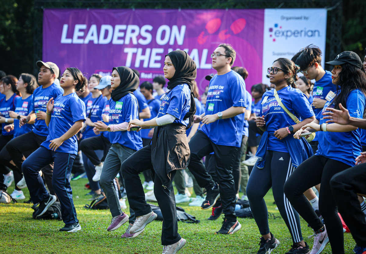 Participants do warm-up exercises during the Leaders On The Walks event at Perdana Botanical Garden today. - BERNAMA