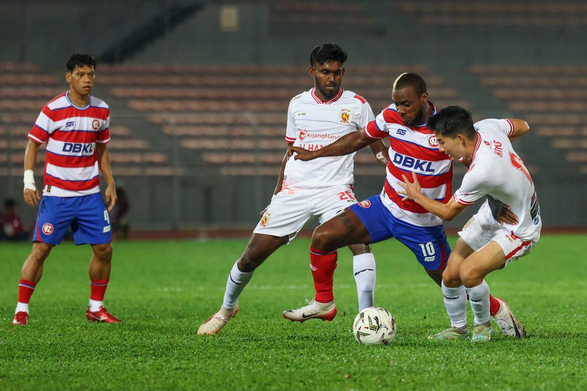Kuala Lumpur City FC player Kpah Sherman (second from right) is challenged by two players from Kelantan The Real Warriors FC during the 2025/2026 FA Cup match at the Kuala Lumpur Football Stadium last night. - BERNAMA